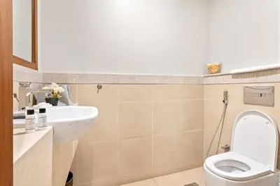 a bathroom with a toilet and a sink at Downtown 2BR Skyline Views & Prime Dubai Stay Near Burj Khalifa, Mall in Dubai