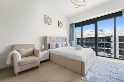 a bedroom with a bed and a chair and a window at StoneTree - Fully Furnished - Brand New in Dubai