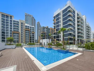 a swimming pool in a city with tall buildings at StoneTree - Fully Furnished - Brand New in Dubai