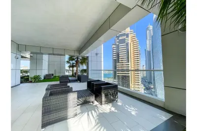 a living room with a view of the city at HAVN - 1 Bedroom in Dubai Marina with Sea Views in Dubai