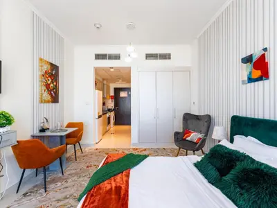 a bedroom with a bed and a living room at Studio in Damac Hills - Modern Comfort with Premium Amenities,by Think Realty in Dubai