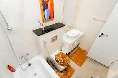 a bathroom with a toilet and a sink at Studio in Damac Hills - Luxurious Living with Premium Amenities, by Think Realty in Dubai