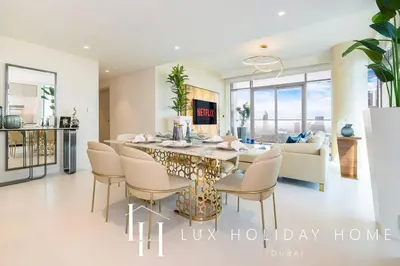 a dining room and living room with a table and chairs at LUX The Marina Vista Beachfront Suite 3 in Dubai