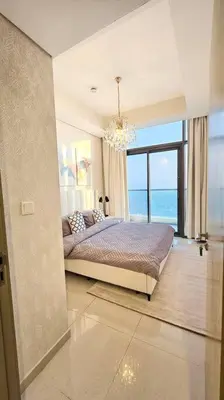 a bedroom with a bed with a view of the ocean at Luxury 3 bedroom Aykon Tower in Dubai