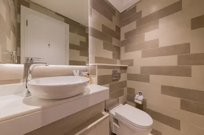 a bathroom with a sink and a toilet at Palm Jumeirah 1BR - Rooftop Infinity Pool in Dubai