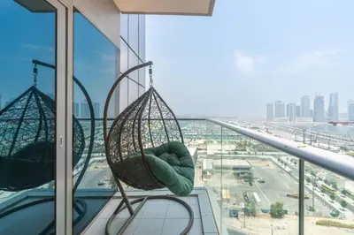 a hammock hanging from a window in a building at Gala Guests - Deluxe Marina View Apartments with Infinity Pool in Dubai