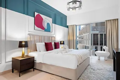 a bedroom with a king sized bed and a desk at Luxury DIFC 1BR Near Dubai Mall, Burj Khalifa with Skyline Views in Dubai