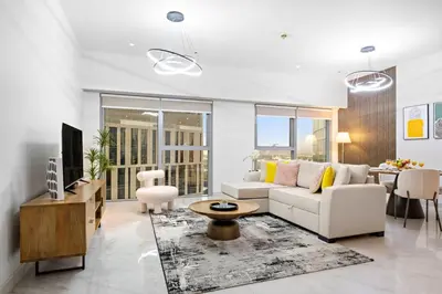 a living room with a white couch and a table at Luxury DIFC 1BR Near Dubai Mall, Burj Khalifa with Skyline Views in Dubai