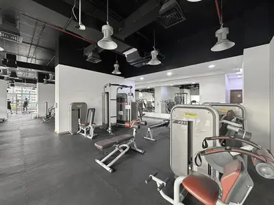 a gym with lots of cardio equipment in a room at Luxury DIFC 1BR Near Dubai Mall, Burj Khalifa with Skyline Views in Dubai