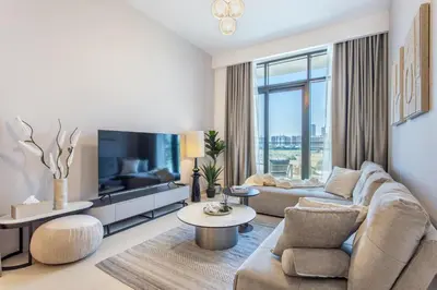 a living room with a couch and a tv at Fantastic1BR Furnished Apt at Azizi Park Avenue! in Dubai