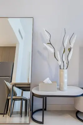 a table with a vase with a plant on it at Fantastic1BR Furnished Apt at Azizi Park Avenue! in Dubai