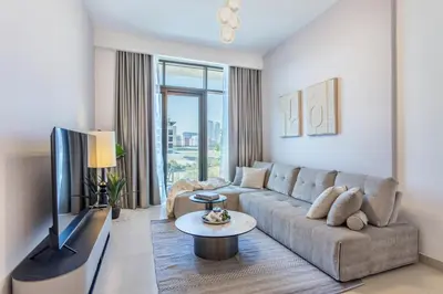 a living room with a couch and a tv at Fantastic1BR Furnished Apt at Azizi Park Avenue! in Dubai