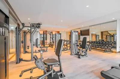 a gym with a lot of treadmills and ellipticals at Brand New 1BR Downtown - Next to Dubai Mall in Dubai