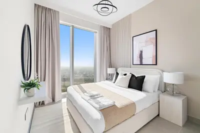 a white bedroom with a large bed and large windows at Silkhaus Beautiful 1 BDR in Heart of Downtown in Dubai