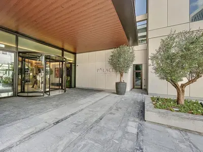 a building with two trees in front of it at Palace Residences - Chic Two Bed with Creek Views in Dubai