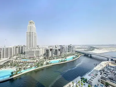 an aerial view of a city with a river and buildings at Palace Residences - Chic Two Bed with Creek Views in Dubai