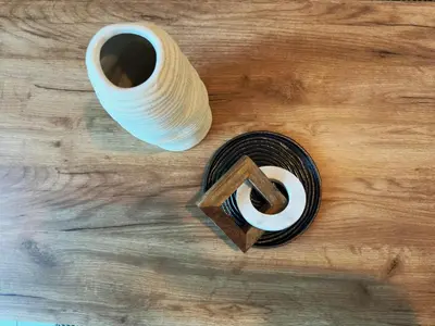 a coil of thread and a cup of coffee on a wooden table at DreamLike Full Pool & Marina View Apartment Dubai in Dubai