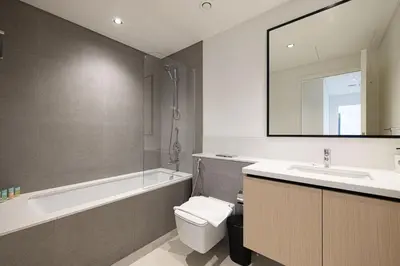 a bathroom with a sink and a toilet and a bath tub at LUXE | 2BR | Sea & City View | 5 Min to Dubai Mall in Dubai