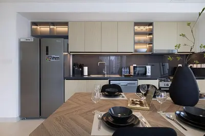 a kitchen with a table with plates and wine glasses at LUXE | 2BR | Sea & City View | 5 Min to Dubai Mall in Dubai