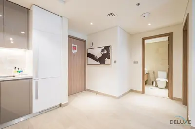 a hallway of a bathroom with a door and a toilet at Stunning 1BR Apartment in Azizi Riviera 42, Al Merkadh by Deluxe Holiday Homes in Dubai