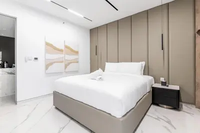 a white bedroom with a large white bed in it at Seaside Elegance - NEW Luxury 3-Bedroom Apt in JBR in Dubai