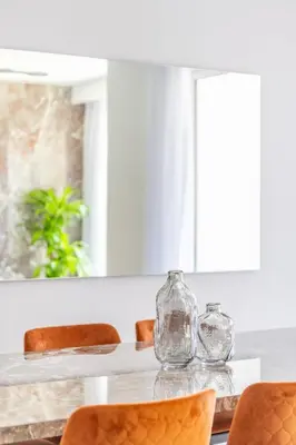 a dining room table with two glass jars on it at Seaside Elegance - NEW Luxury 3-Bedroom Apt in JBR in Dubai