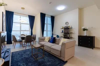 a living room with a couch and a table at Dubai Modern Apartment l Sleeps 4 l 2 Baths in Dubai
