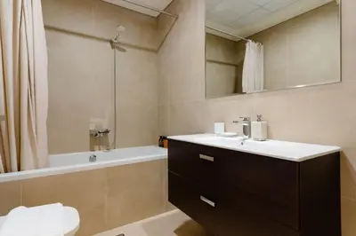 a bathroom with a sink and a bath tub at Dubai Modern Apartment l Sleeps 4 l 2 Baths in Dubai