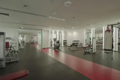 a gym with treadmills and machines in a room at Dubai Modern Apartment l Sleeps 4 l 2 Baths in Dubai