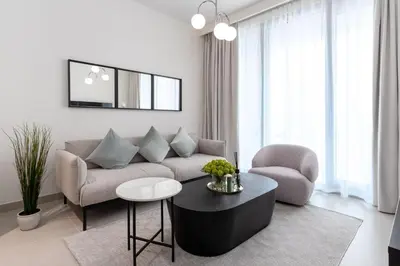 a living room with a couch and a table at Luxury Escapes - Stylish 2BR Apt with City View in Forte Downtown in Dubai