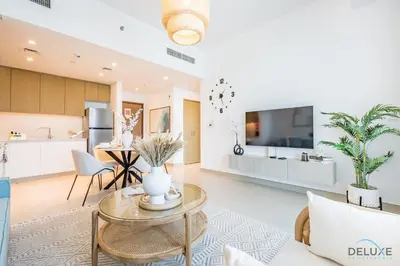 a living room with a table and a kitchen at Alluring 1BR with Marina View at 5242 Tower 2 Dubai Marina by Deluxe Holiday Homes in Dubai