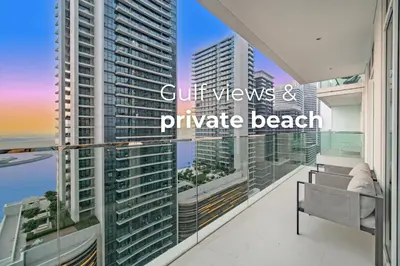 a balcony with a view of the ocean and buildings at SettlerHomes - Seaside Lux Marina near Private Beach in Dubai