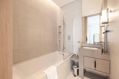 a white bathroom with a tub and a sink at Address Beach Resort JBR - 1 BR in Dubai