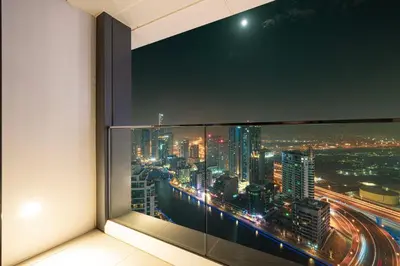 a room with a view of a city at night at Address Beach Resort JBR - 1 BR in Dubai