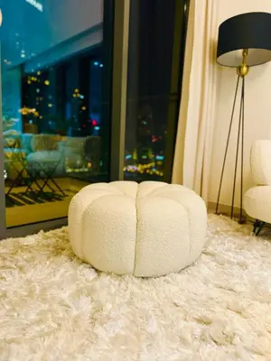 a white chair sitting on top of a white rug at Incredible Burj Khalifa Views, Next to Dubai Mall in Dubai