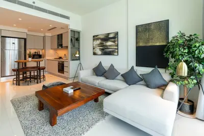 a living room with two couches and a coffee table at 2 BR Private Beach Access & Marina View in Dubai