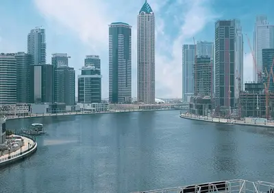 a river in a city with tall buildings at Lux Studio in Downtown - Damac Maison Prive - Near Burj Khalifa in Dubai