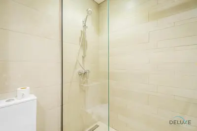 a shower with a glass door in a bathroom at Inviting 1BR Apartment in Azizi Riviera 32, Al Merkadh by Deluxe Holiday Homes in Dubai