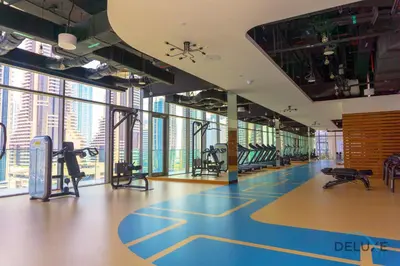 a gym with treadmills and exercise equipment in a building at Chic 1BR in The Residence at Marina Gate 2, Dubai Marina by Deluxe Holiday Homes in Dubai