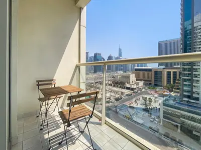 two benches on a balcony with a view of a city at StoneTree - Newly Furnished - Near Metro in Dubai