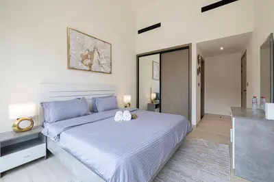 a bedroom with a bed with two towels on it at 1-Bed in Binghatti Crescent, Next to Circle Mall in Dubai