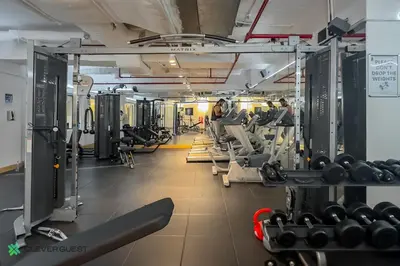 a gym with tread machines and people in it at Clever Guest 025 Dubai Gate 1 in Dubai