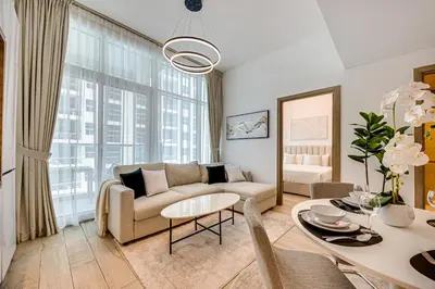 a living room with a couch and a table at Cozy 2 bedroom apartment in Dubai Marina in Dubai