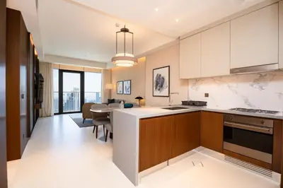 a kitchen with a table and a dining room at Escape24 2BR in Address Opera with Skyline Views near Burj Khalifa in Dubai