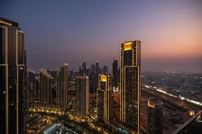 a city skyline at night with tall buildings at Escape24 2BR in Address Opera with Skyline Views near Burj Khalifa in Dubai