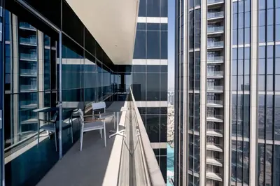 a balcony with a table and chairs on a building at Escape24 2BR in Address Opera with Skyline Views near Burj Khalifa in Dubai