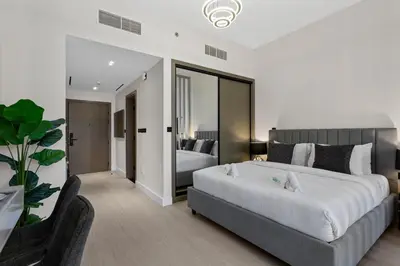 a bedroom with a large bed and a large mirror at Studio Retreat with Canal and Burj Khalifa Views in Dubai