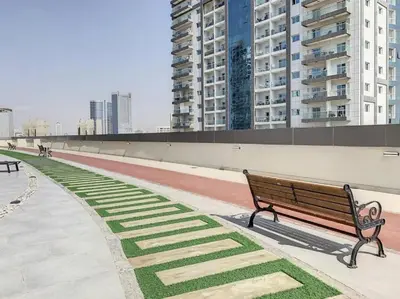 a park bench in a city with tall buildings at Stylish Studio Urban Retreat in Dubai