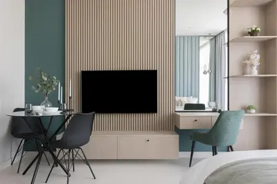a bedroom with a tv and a table and chairs at Cozy Studio in Westwood By IMTIAZ in Dubai