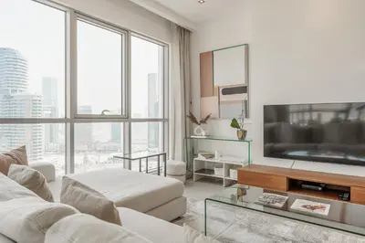 a living room with a couch and a tv at Prime Downtown 2BR Retreat in Dubai
